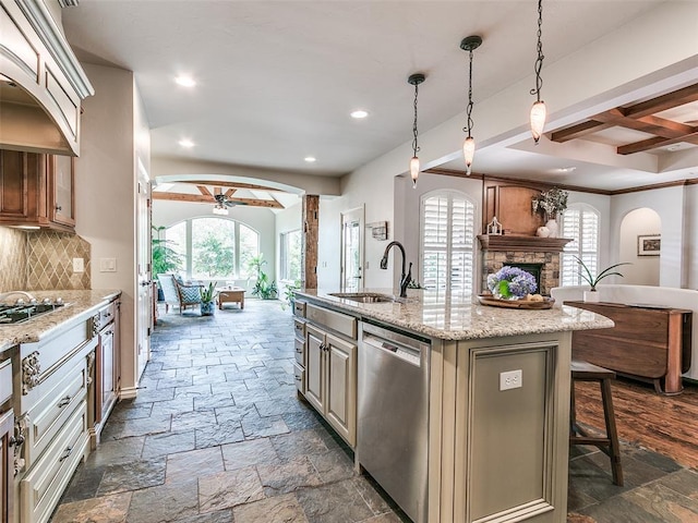 7612 NW 134th St, Oklahoma City, OK 73142 - kitchen with stainless steel dishwasher, a ceiling fan, open floor plan, a sink, and stone tile floors