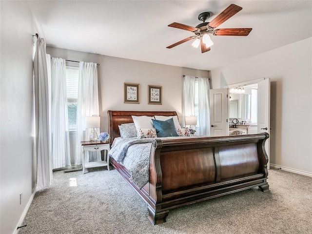 7612 NW 134th St, Oklahoma City, OK 73142 - carpeted bedroom featuring multiple windows, baseboards, a ceiling fan, and ensuite bathroom