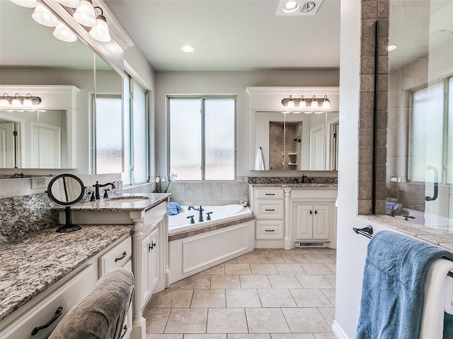 7612 NW 134th St, Oklahoma City, OK 73142 - full bathroom featuring a garden tub, two vanities, a stall shower, recessed lighting, and tile patterned flooring