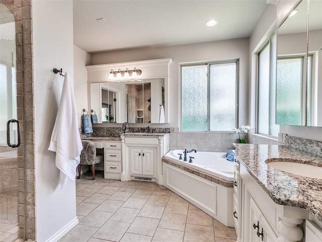 7612 NW 134th St, Oklahoma City, OK 73142 - full bath featuring two vanities, a stall shower, a bath, and recessed lighting