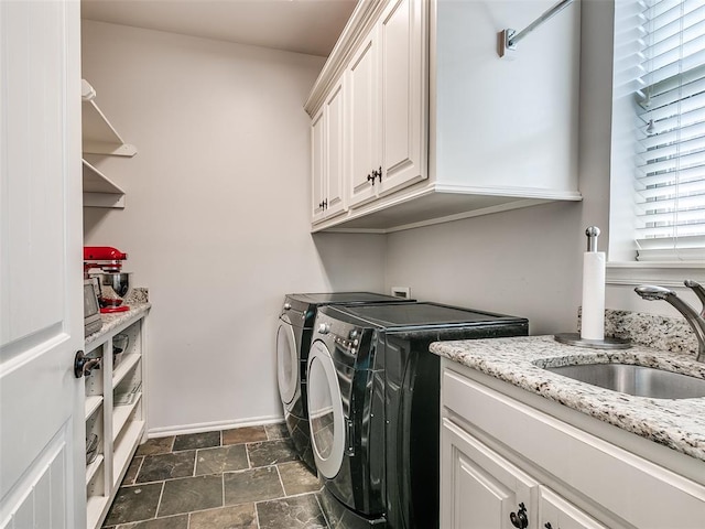 7612 NW 134th St, Oklahoma City, OK 73142 - laundry area featuring cabinet space, independent washer and dryer, dark stone finish floors, and baseboards