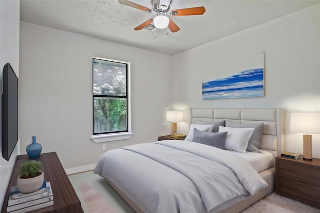 bedroom featuring baseboards and ceiling fan