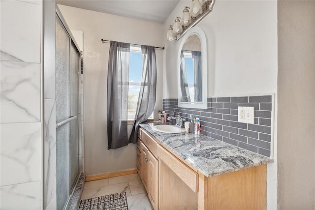 3234 N Hiwassee Rd, Choctaw, OK 73020 - bathroom with vanity, baseboards, marble look tile flooring, and tasteful backsplash