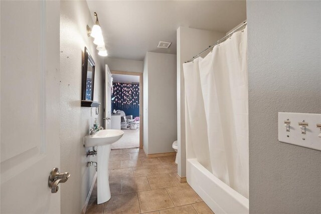 3234 N Hiwassee Rd, Choctaw, OK 73020 - bathroom featuring toilet, a sink, tile patterned flooring, and a textured wall