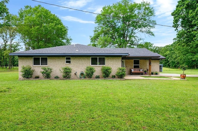 2590 Old 21 Rd, Idabel, OK 74745 - ranch-style house with a front yard, brick siding, and a patio area