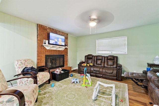 3217 NW 34th St, Oklahoma City, OK 73112 - living room featuring wood finished floors, ceiling fan, and a brick fireplace