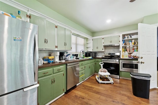 3217 NW 34th St, Oklahoma City, OK 73112 - kitchen with stainless steel appliances, open shelves, under cabinet range hood, dark countertops, and green cabinetry
