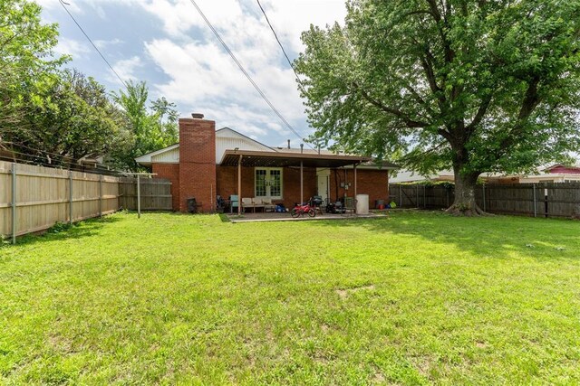 3217 NW 34th St, Oklahoma City, OK 73112 - back of house with a chimney, french doors, and a patio