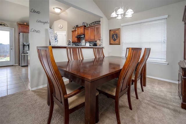 1528 Fawn Run Xing, Norman, OK 73071 - dining area featuring light carpet, a chandelier, vaulted ceiling, baseboards, and healthy amount of natural light