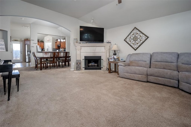 1528 Fawn Run Xing, Norman, OK 73071 - carpeted living room with vaulted ceiling, arched walkways, and a tile fireplace