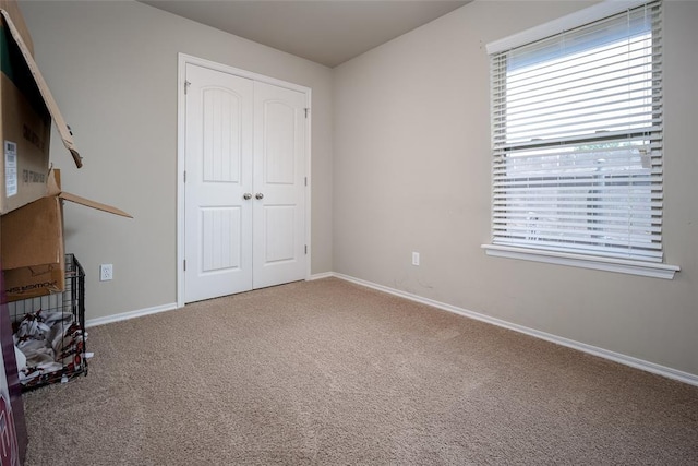 1528 Fawn Run Xing, Norman, OK 73071 - unfurnished bedroom with carpet, a closet, and baseboards