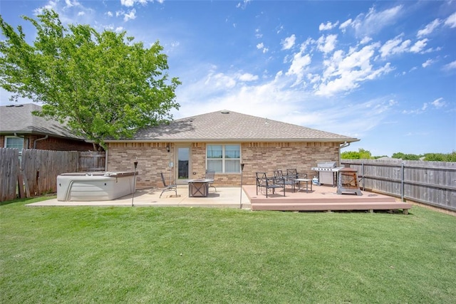 1528 Fawn Run Xing, Norman, OK 73071 - back of property featuring a deck, brick siding, a patio area, and roof with shingles