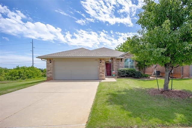 1528 Fawn Run Xing, Norman, OK 73071 - view of front of property with concrete driveway, an attached garage, a front lawn, brick siding, and roof with shingles