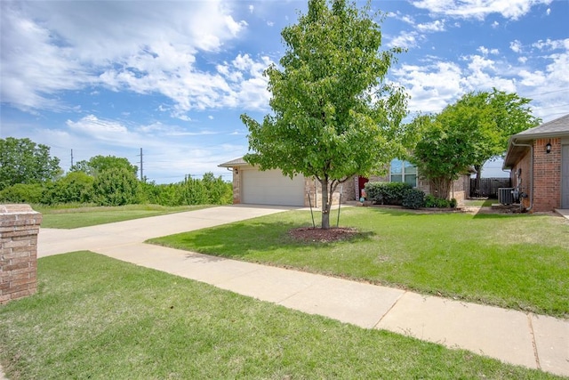 1528 Fawn Run Xing, Norman, OK 73071 - view of green lawn with driveway, an attached garage, and central AC unit