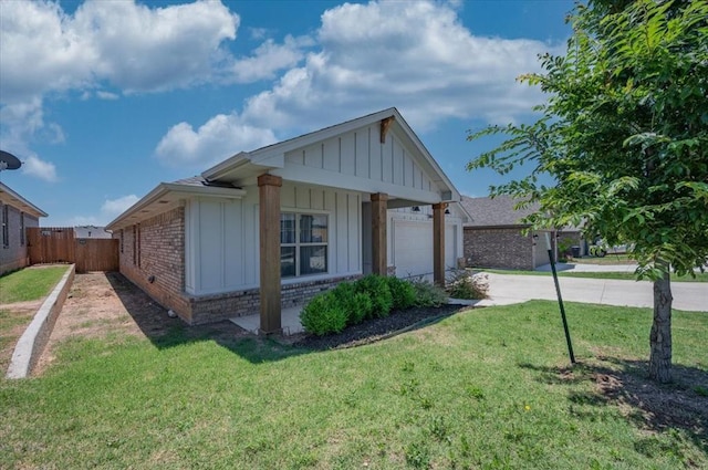 12824 NW 4th Ter, Yukon, OK 73099 - view of property exterior featuring board and batten siding, driveway, brick siding, and an attached garage