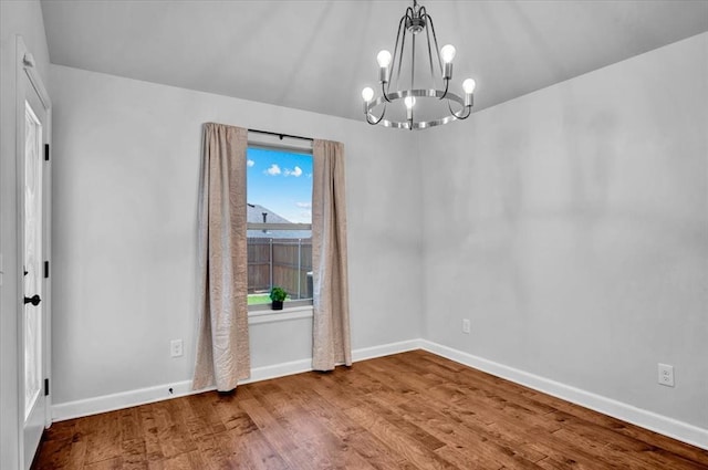 12824 NW 4th Ter, Yukon, OK 73099 - empty room featuring a chandelier, baseboards, and wood finished floors