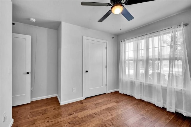 12824 NW 4th Ter, Yukon, OK 73099 - unfurnished bedroom with wood finished floors, baseboards, and a ceiling fan