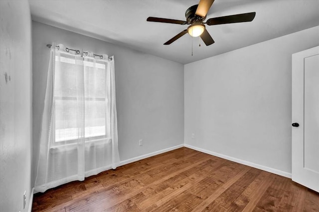 12824 NW 4th Ter, Yukon, OK 73099 - empty room with wood finished floors, ceiling fan, and baseboards