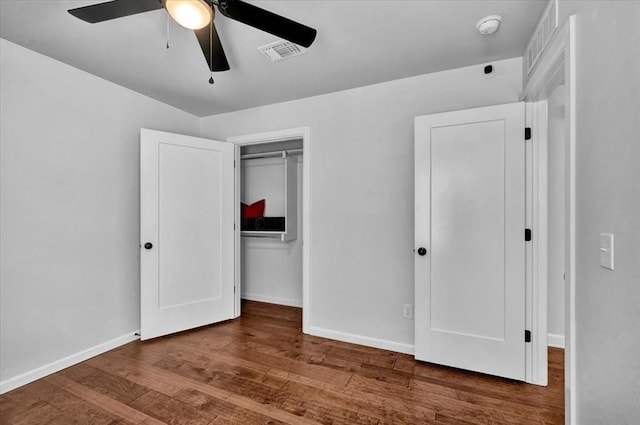 12824 NW 4th Ter, Yukon, OK 73099 - unfurnished bedroom featuring wood finished floors, baseboards, a closet, and ceiling fan
