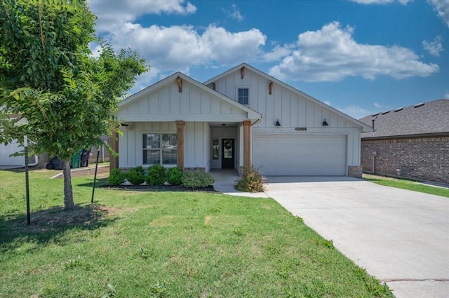 12824 NW 4th Ter, Yukon, OK 73099 - view of front facade with board and batten siding, a garage, driveway, and a front yard