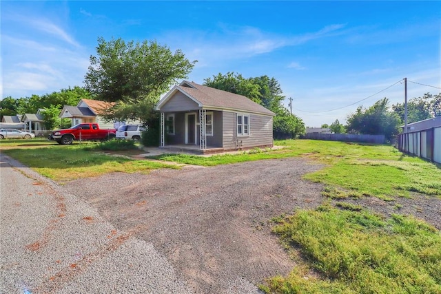 6017 Pat Ave, Oklahoma City, OK 73149 - view of front facade with a porch and a front lawn