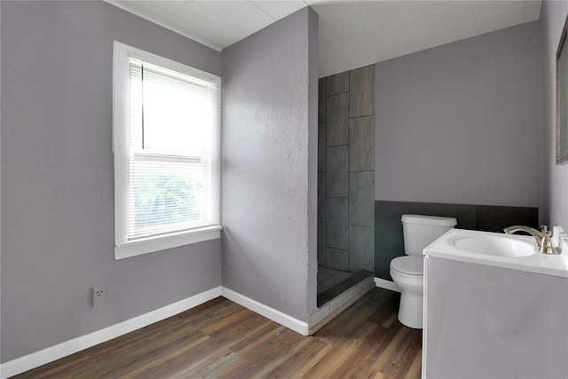 6017 Pat Ave, Oklahoma City, OK 73149 - bathroom with toilet, plenty of natural light, wood finished floors, and tiled shower