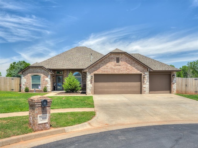 12005 NW 139th St, Piedmont, OK 73078 - french country style house with an attached garage, driveway, roof with shingles, and brick siding