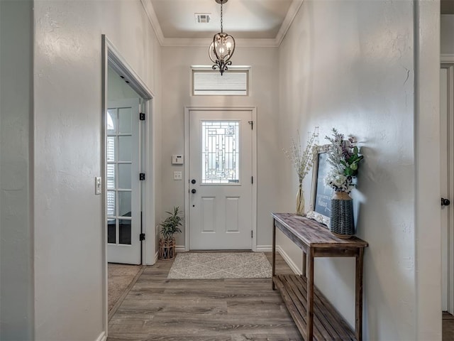 12005 NW 139th St, Piedmont, OK 73078 - foyer entrance featuring wood finished floors, ornamental molding, and baseboards