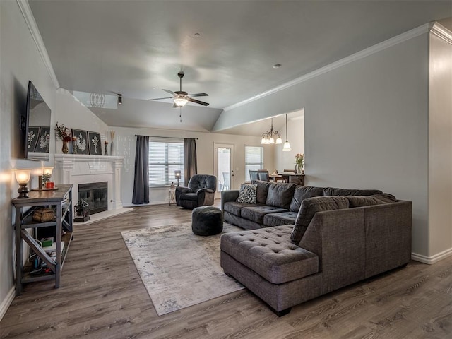 12005 NW 139th St, Piedmont, OK 73078 - living area featuring ornamental molding, ceiling fan, a glass covered fireplace, baseboards, and lofted ceiling