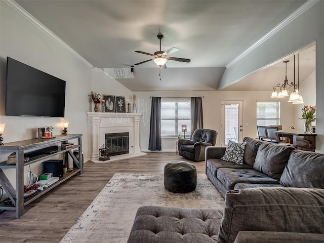 12005 NW 139th St, Piedmont, OK 73078 - living room featuring lofted ceiling, a glass covered fireplace, ceiling fan, ornamental molding, and wood finished floors