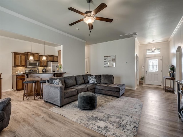 12005 NW 139th St, Piedmont, OK 73078 - living room with ornamental molding, ceiling fan, light wood-style flooring, and baseboards