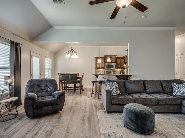 12005 NW 139th St, Piedmont, OK 73078 - living room featuring light wood finished floors, a ceiling fan, crown molding, lofted ceiling, and a chandelier