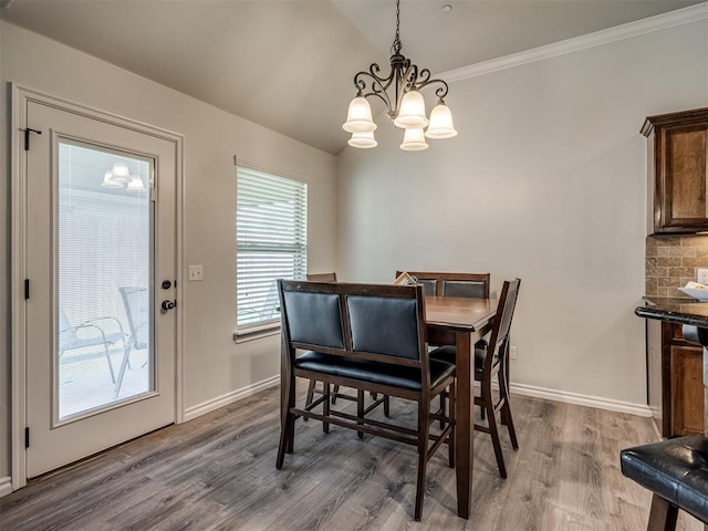 12005 NW 139th St, Piedmont, OK 73078 - dining room featuring a chandelier, wood finished floors, crown molding, and baseboards