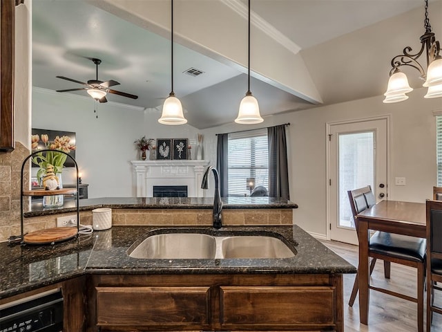 12005 NW 139th St, Piedmont, OK 73078 - kitchen with a sink, a fireplace, open floor plan, dark stone counters, and ceiling fan