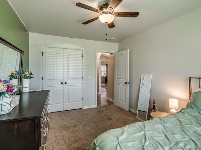 12005 NW 139th St, Piedmont, OK 73078 - carpeted bedroom with arched walkways, baseboards, ceiling fan, and a closet