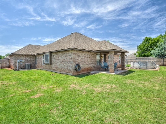 12005 NW 139th St, Piedmont, OK 73078 - rear view of house with cooling unit, a shingled roof, a swimming pool, a patio, and brick siding
