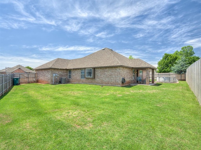 12005 NW 139th St, Piedmont, OK 73078 - back of house featuring brick siding, a patio area, roof with shingles, and central air condition unit