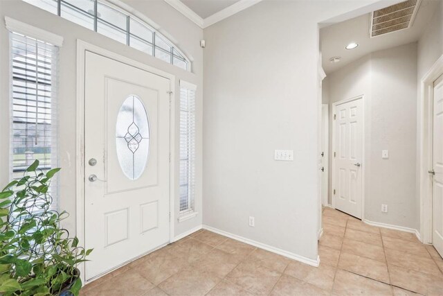 1701 Tifton Dr, Edmond, OK 73012 - entrance foyer featuring light tile patterned floors, ornamental molding, baseboards, and recessed lighting