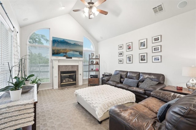 1701 Tifton Dr, Edmond, OK 73012 - living room with ceiling fan, high vaulted ceiling, a glass covered fireplace, and light colored carpet
