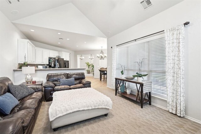 1701 Tifton Dr, Edmond, OK 73012 - living room with a chandelier, recessed lighting, baseboards, light colored carpet, and high vaulted ceiling