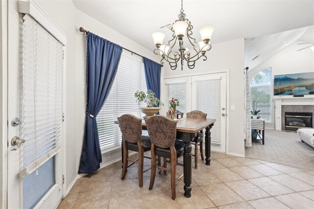 1701 Tifton Dr, Edmond, OK 73012 - dining space with a chandelier, light tile patterned floors, baseboards, and a fireplace