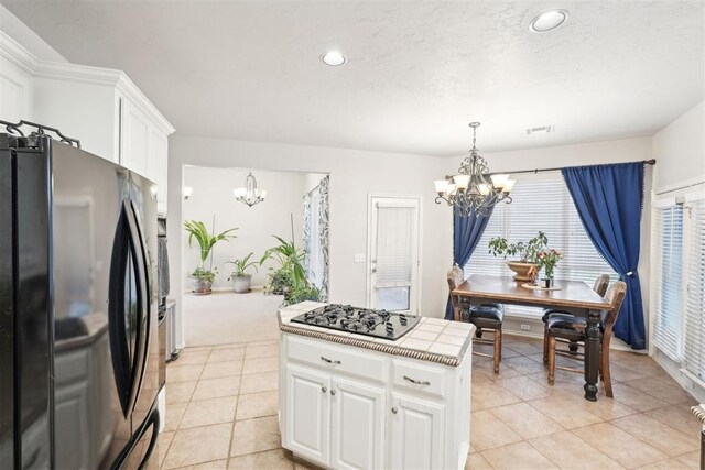 1701 Tifton Dr, Edmond, OK 73012 - kitchen featuring black appliances, a chandelier, white cabinets, light tile patterned floors, and recessed lighting