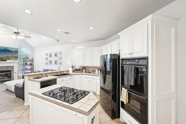 1701 Tifton Dr, Edmond, OK 73012 - kitchen with black appliances, a sink, a peninsula, open floor plan, and a ceiling fan