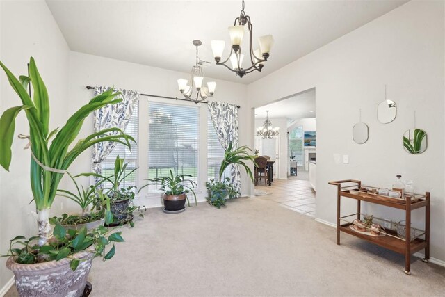 1701 Tifton Dr, Edmond, OK 73012 - dining room featuring a chandelier, light carpet, and baseboards