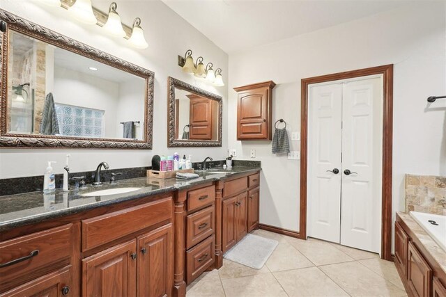 1701 Tifton Dr, Edmond, OK 73012 - full bath featuring tile patterned flooring, double vanity, and a tub