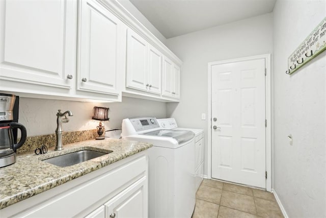 1701 Tifton Dr, Edmond, OK 73012 - clothes washing area featuring washer and dryer, cabinet space, light tile patterned floors, and baseboards