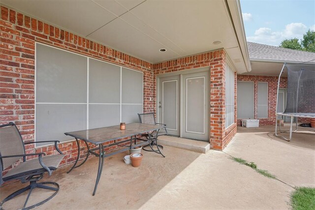 1701 Tifton Dr, Edmond, OK 73012 - view of patio / terrace with a trampoline and outdoor dining area