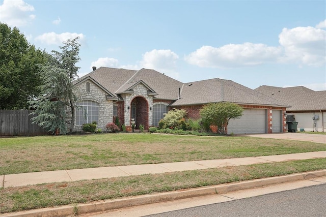 1701 Tifton Dr, Edmond, OK 73012 - french provincial home with stone siding, a garage, driveway, and roof with shingles
