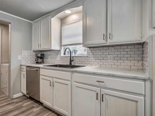 813 Branchwood Ct, Norman, OK 73072 - kitchen featuring a sink, stainless steel dishwasher, light wood finished floors, white cabinets, and decorative backsplash
