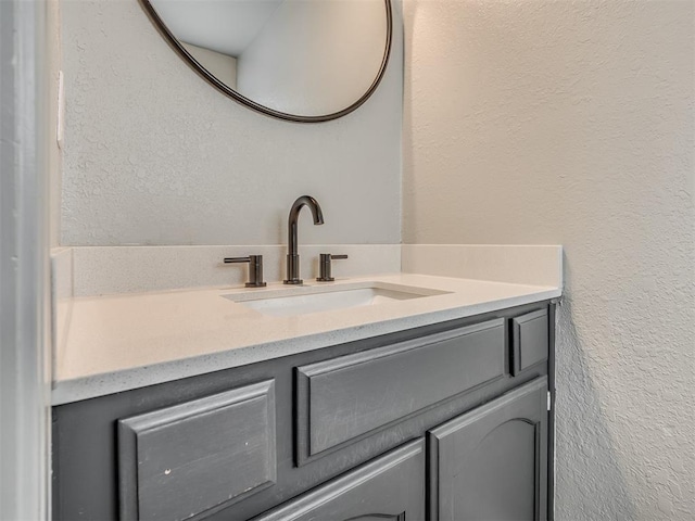 813 Branchwood Ct, Norman, OK 73072 - bathroom featuring vanity and a textured wall